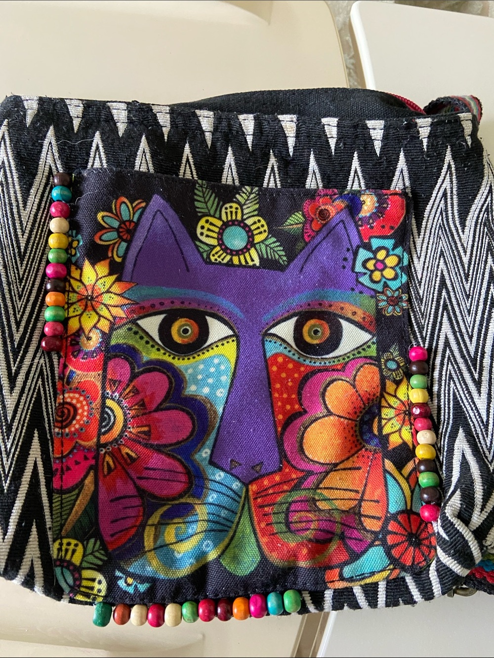 Laurel Burch embroidered crossbody bag featuring a multi-colored cat-face